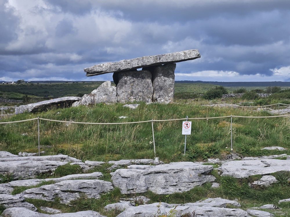 Poulnabrone Dolmen standing on the limestone pavement of the Burren under a heavy sky